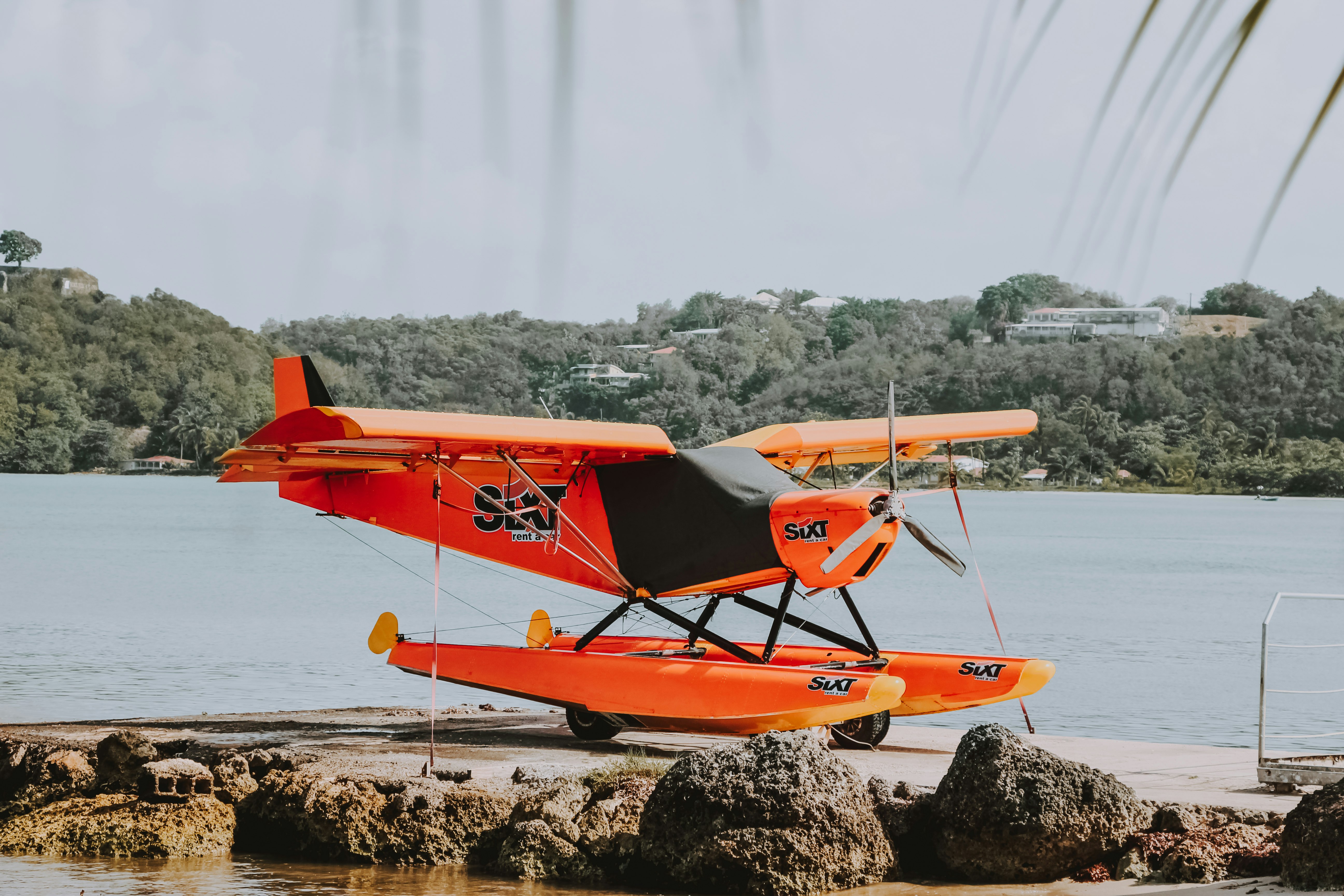 orange sea plane parked in dock